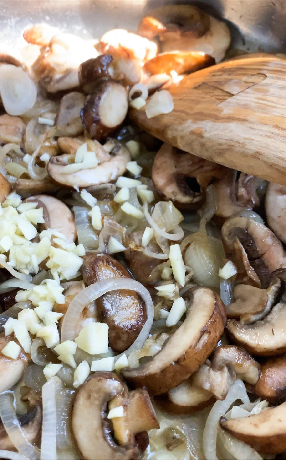 How to make mushroom ravioli in cream sauce- sautéing mushrooms with shallots and garlic adding white wine. 