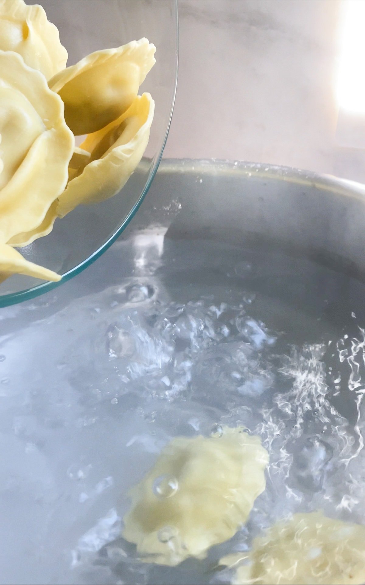 How to make mushroom ravioli in cream sauce- boiling the ravioli in boiling salted water.