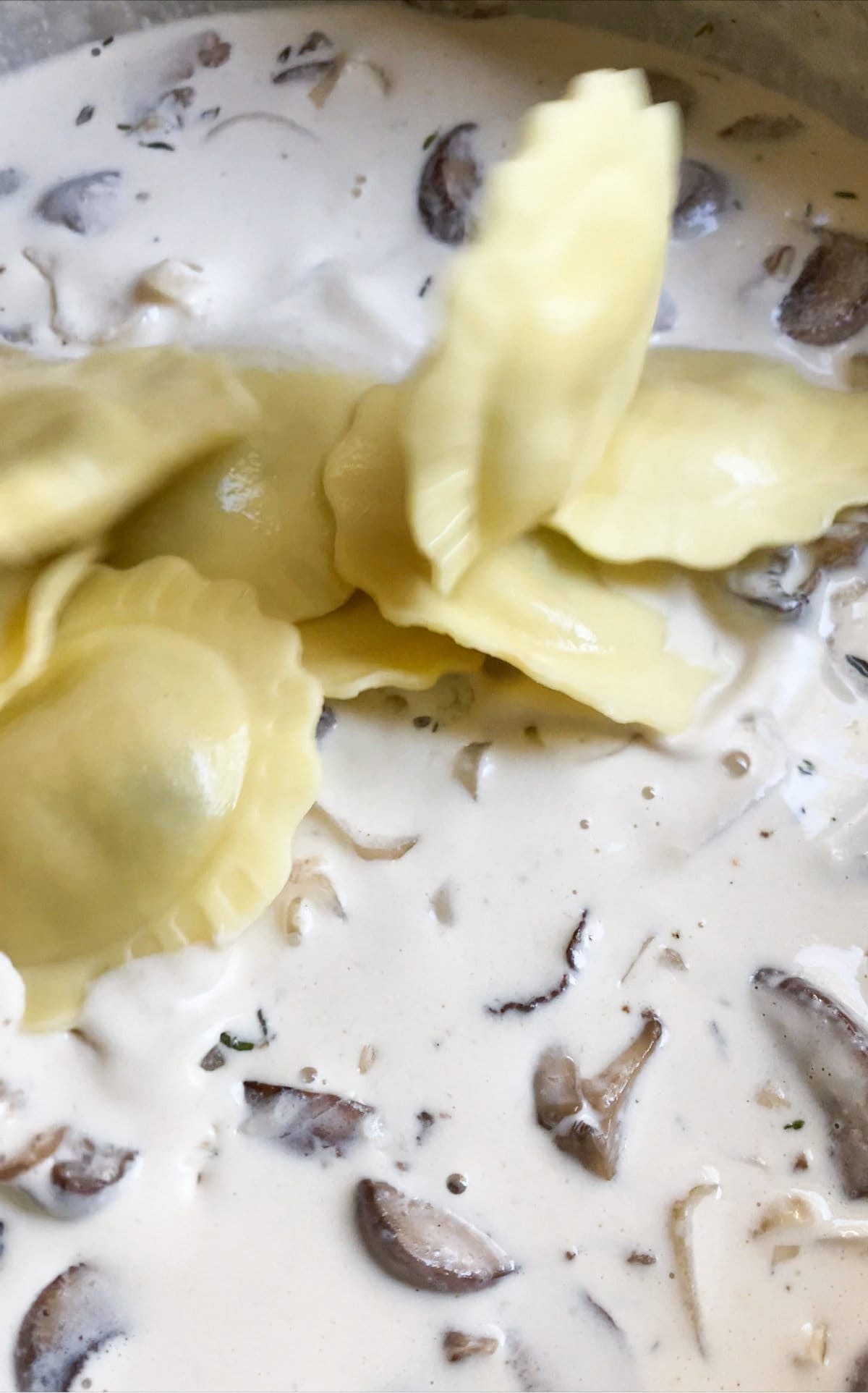 How to make mushroom ravioli in cream sauce- adding ravioli to mushroom cream sauce