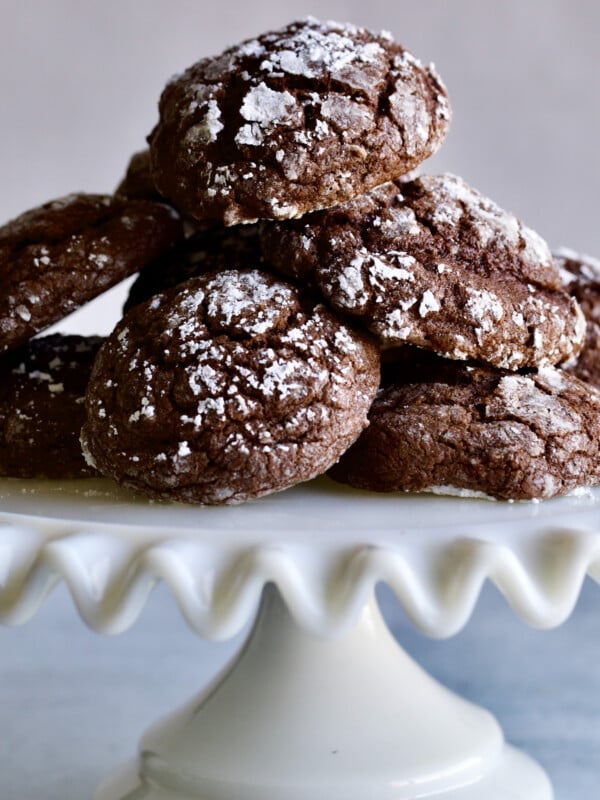 Chocolate spice cookies piled on a raised platter.