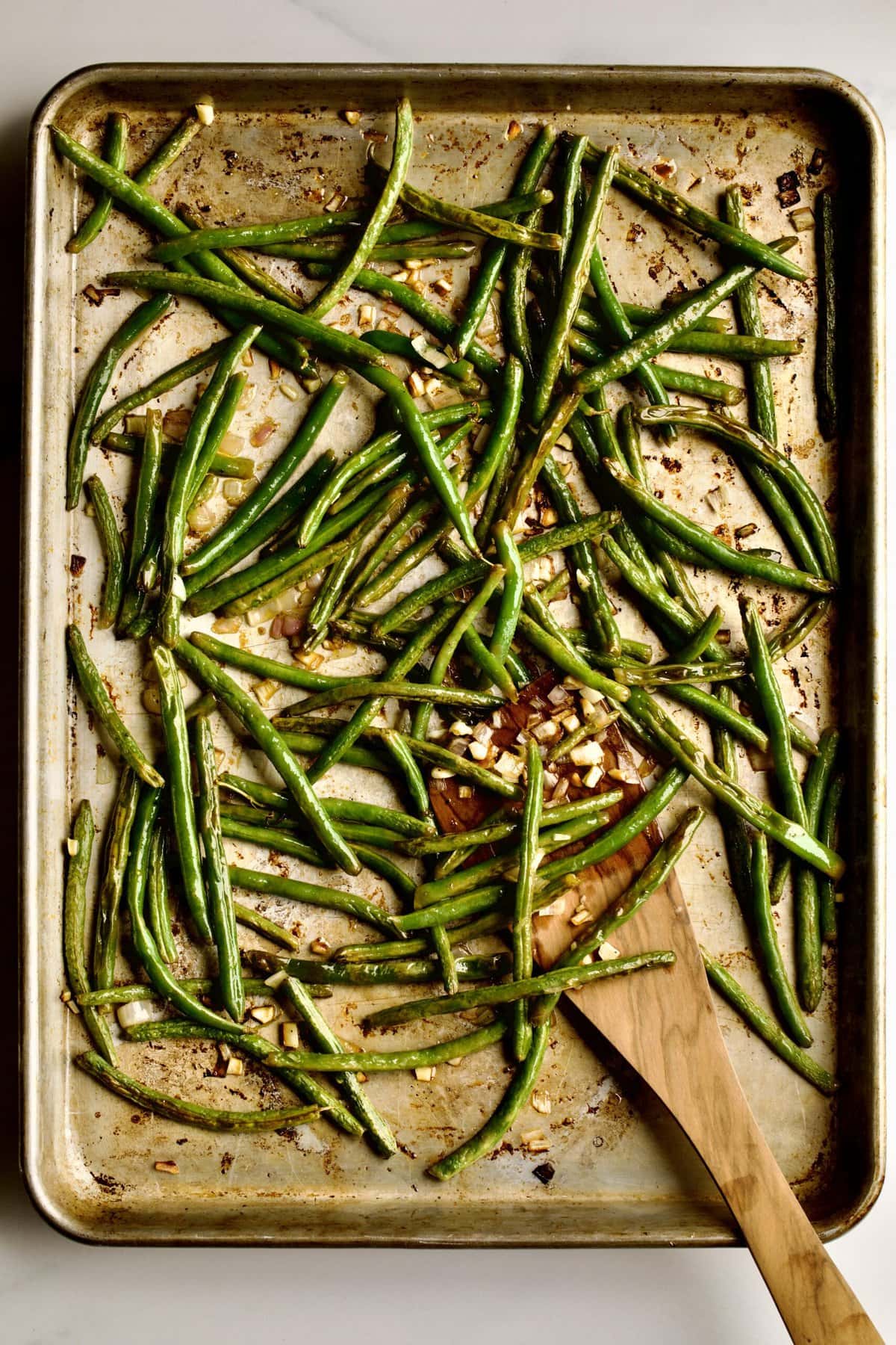 placing green beans on sheet pan to bake. (process after baking)