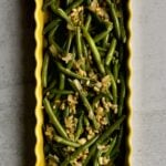 Sautéed Frozen Green Beans Recipe (Easy) on a yellow serving platter.