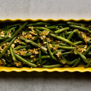 Saut&eacute;ed Frozen Green Beans Recipe (Easy) on a yellow serving platter.