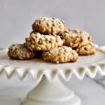 pignoli cookies on small ruffled cake platter