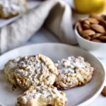 [pgnoli cookies on a plate with a bite taken out of a cookie.