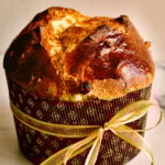 Panettone in a paper wrapper tied with a bow.