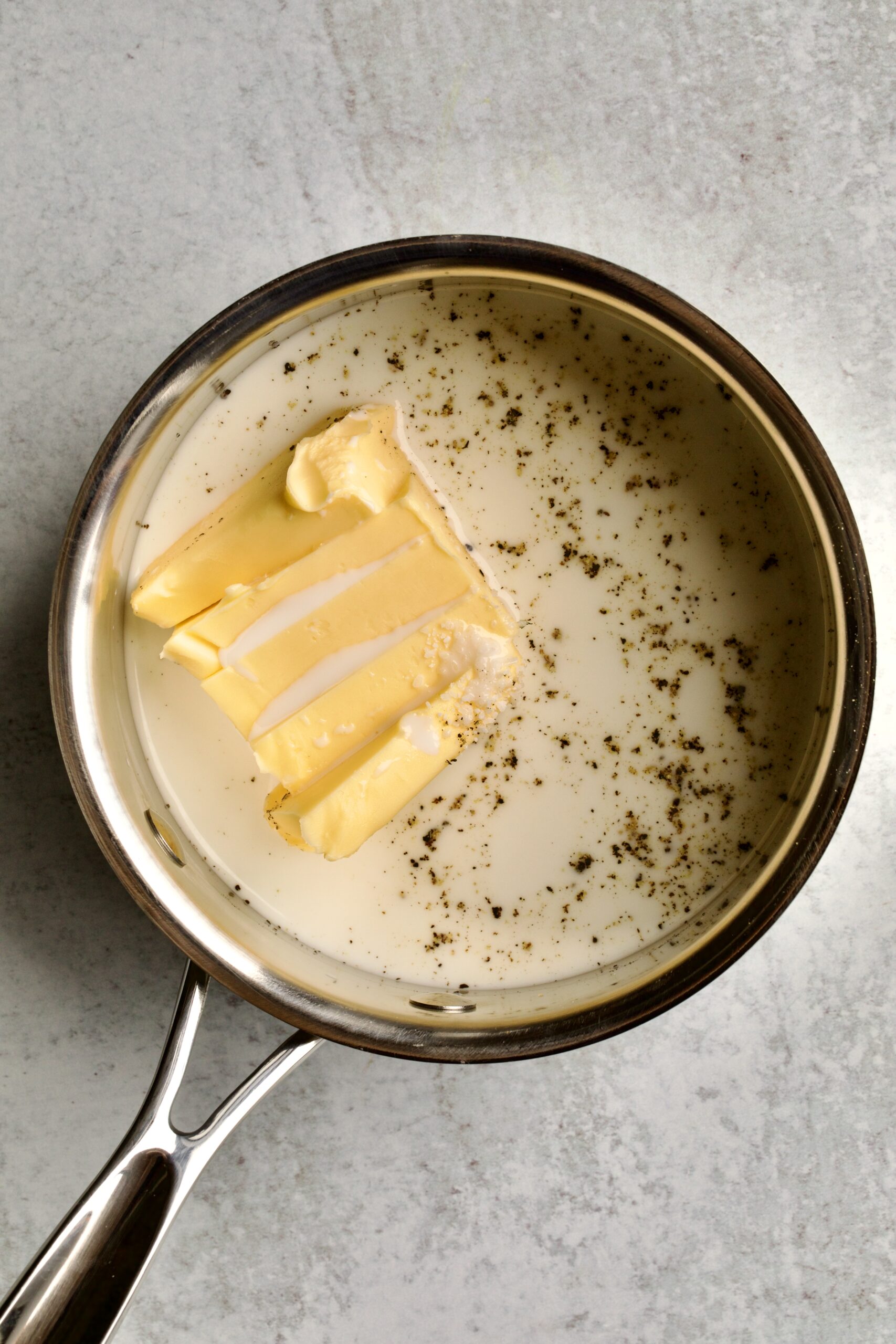 process for making redskin mashed potatoes- melting butter with salt, pepper, and milk