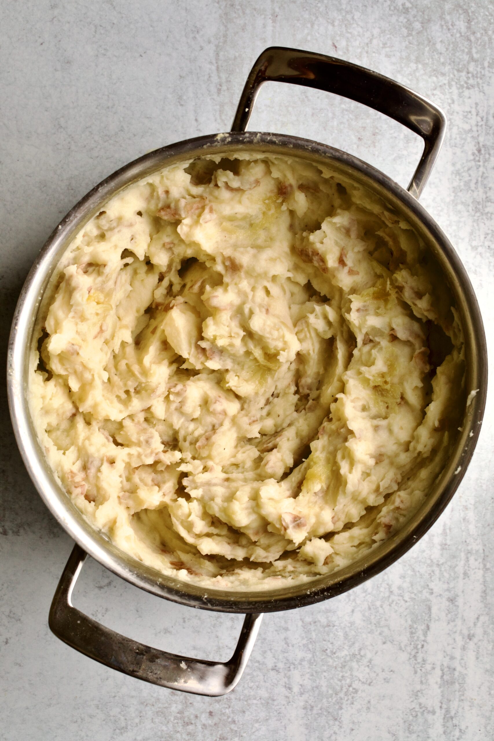 process for making redskin mashed potatoes- mashing potatoes in pot