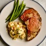 Plate with prime rib and multiple sides.