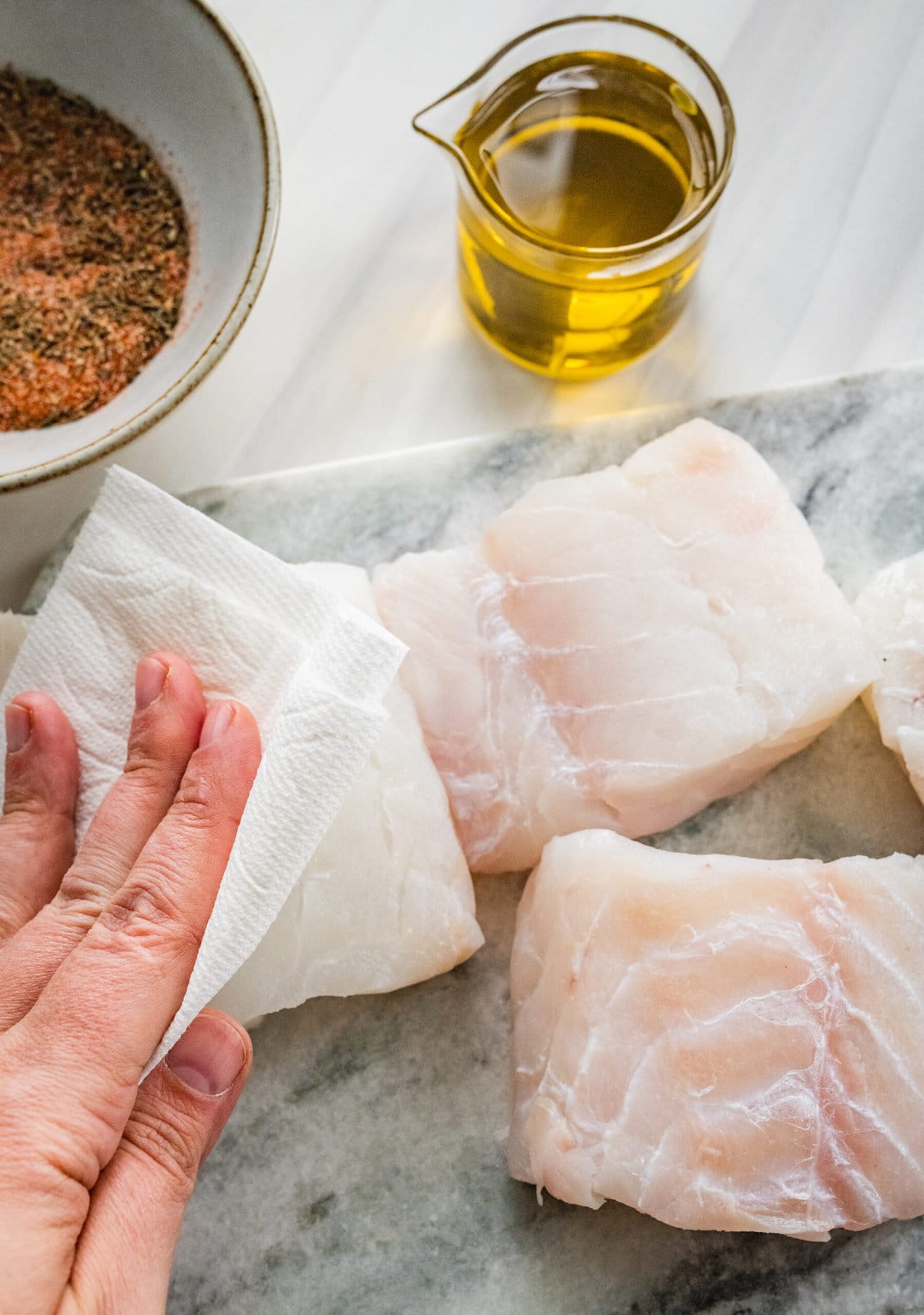 Process for making blackened cod- patting fish dry.