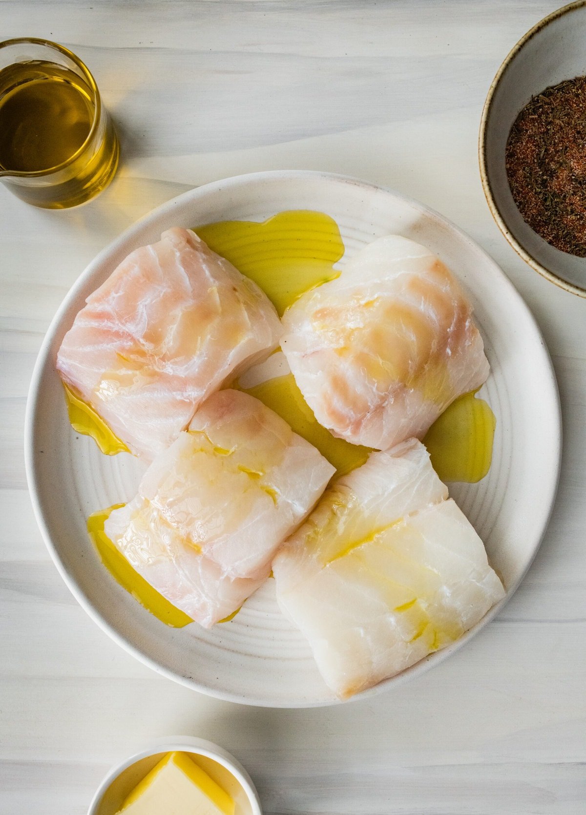 Process for making blackened cod- putting oil on fish.