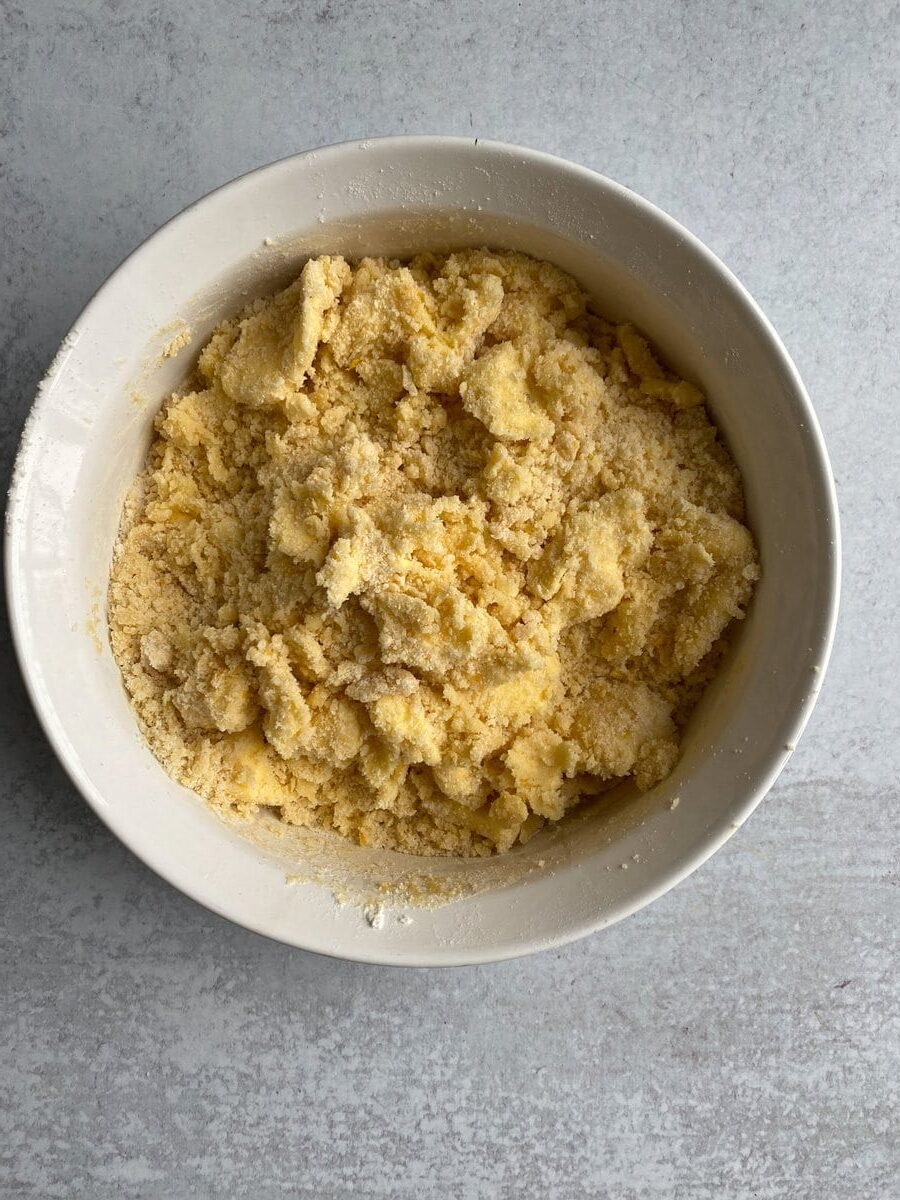 Mixing butter into egg and flour mixture.