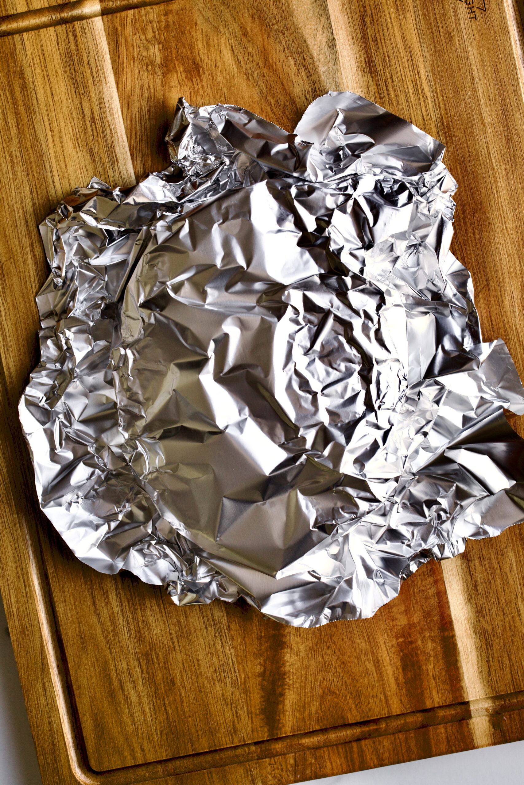 covering steak with tinfoil to let it rest.