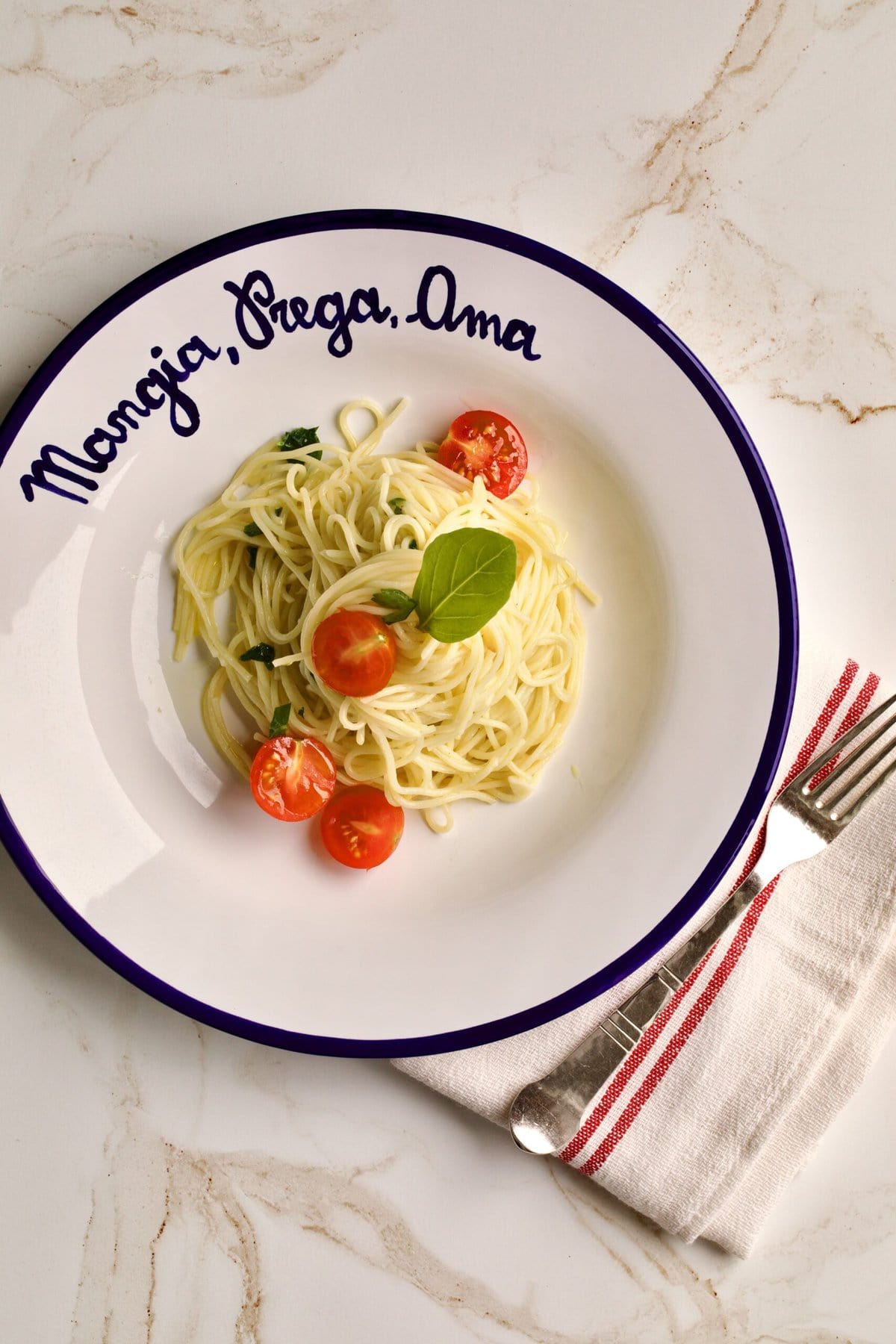 plate of angel hair pasta with herbs and garlic.