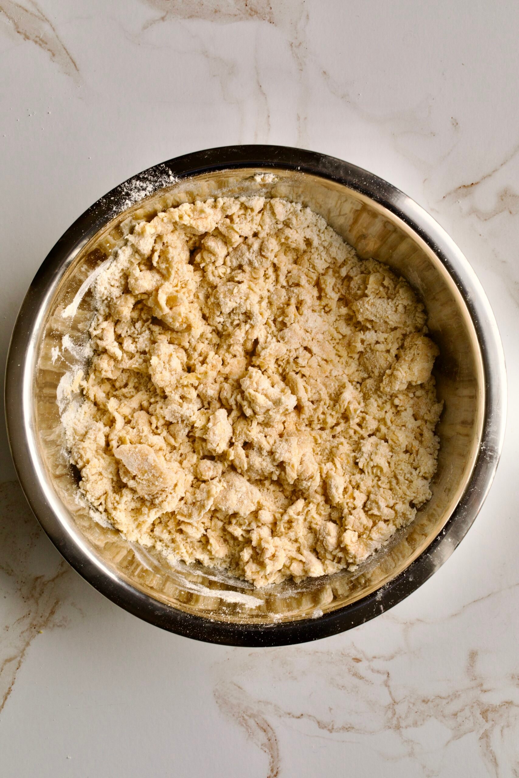 process of making chiacchiere: mixing dough by hand.