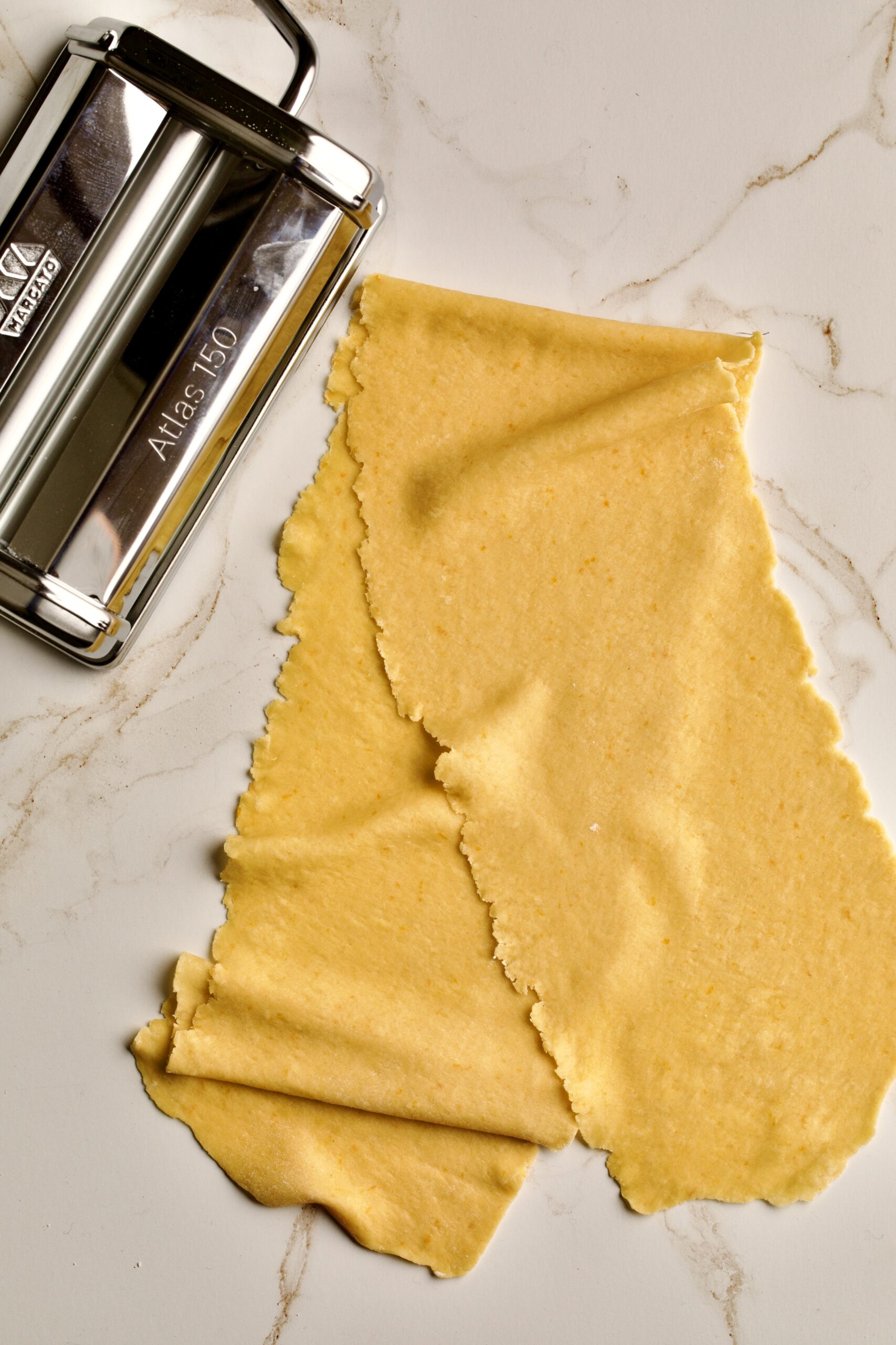 process of making chiacchiere: rolling out the dough phase 4 keeps getting thinner.