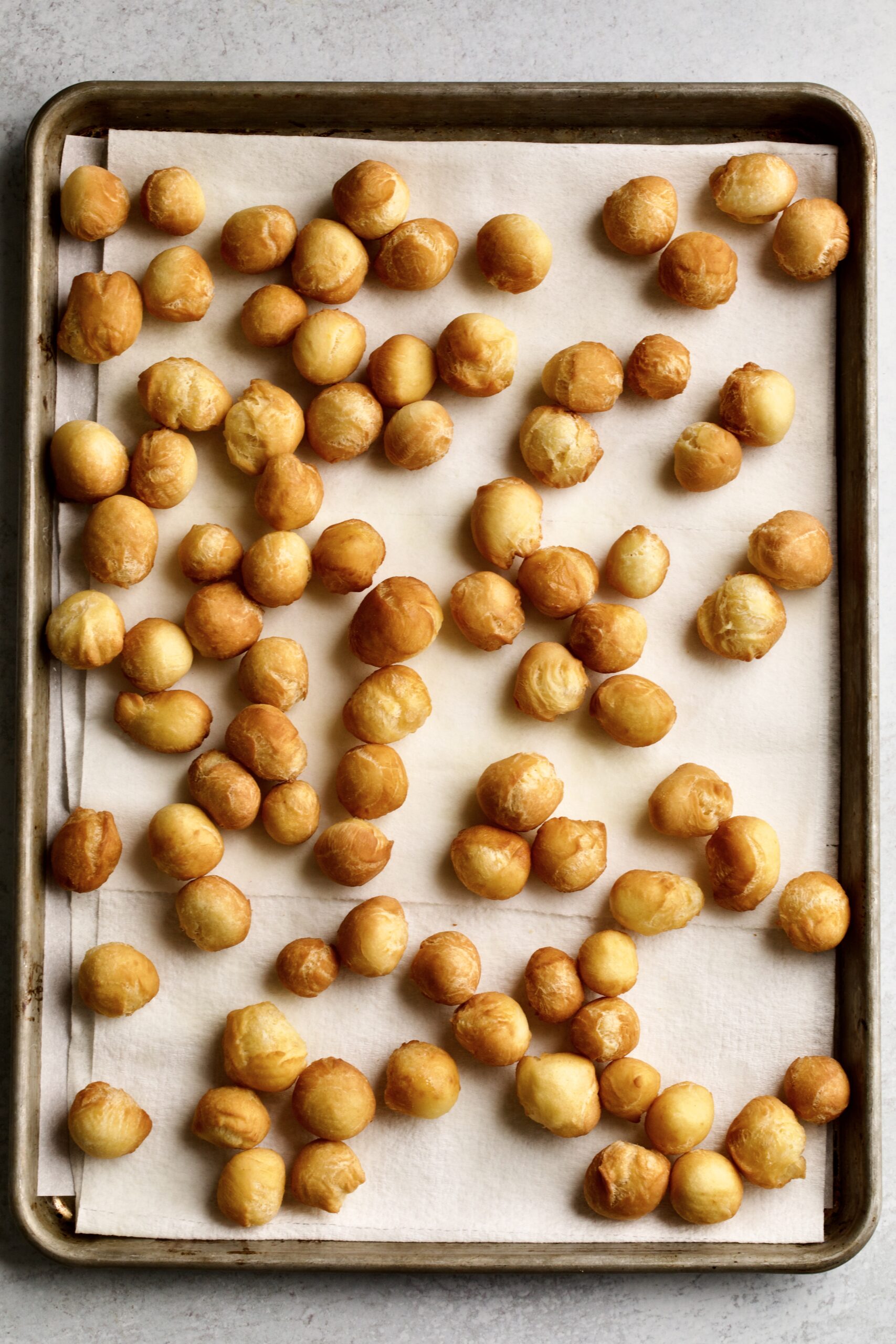 Dough balls draining on paper towels.