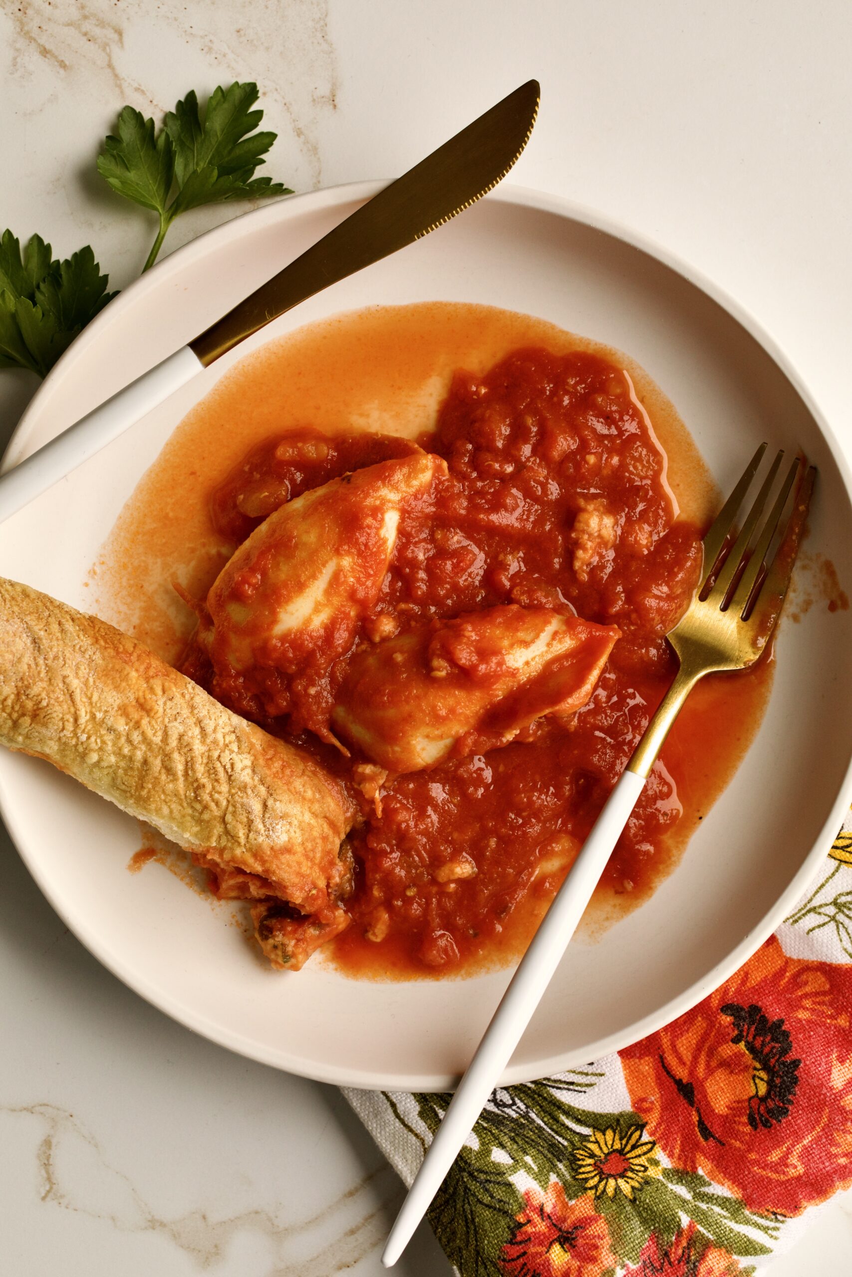 stuffed calamari with tomato sauce served in a plate with crusty bread