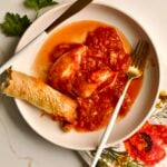 stuffed calamari with tomato sauce served in a plate with crusty bread