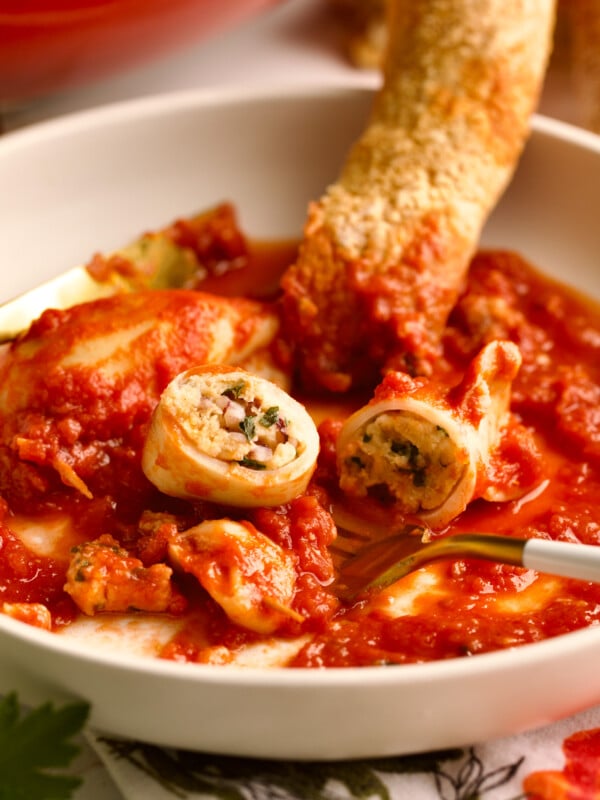Stuffed calamari on a plate with a fork.