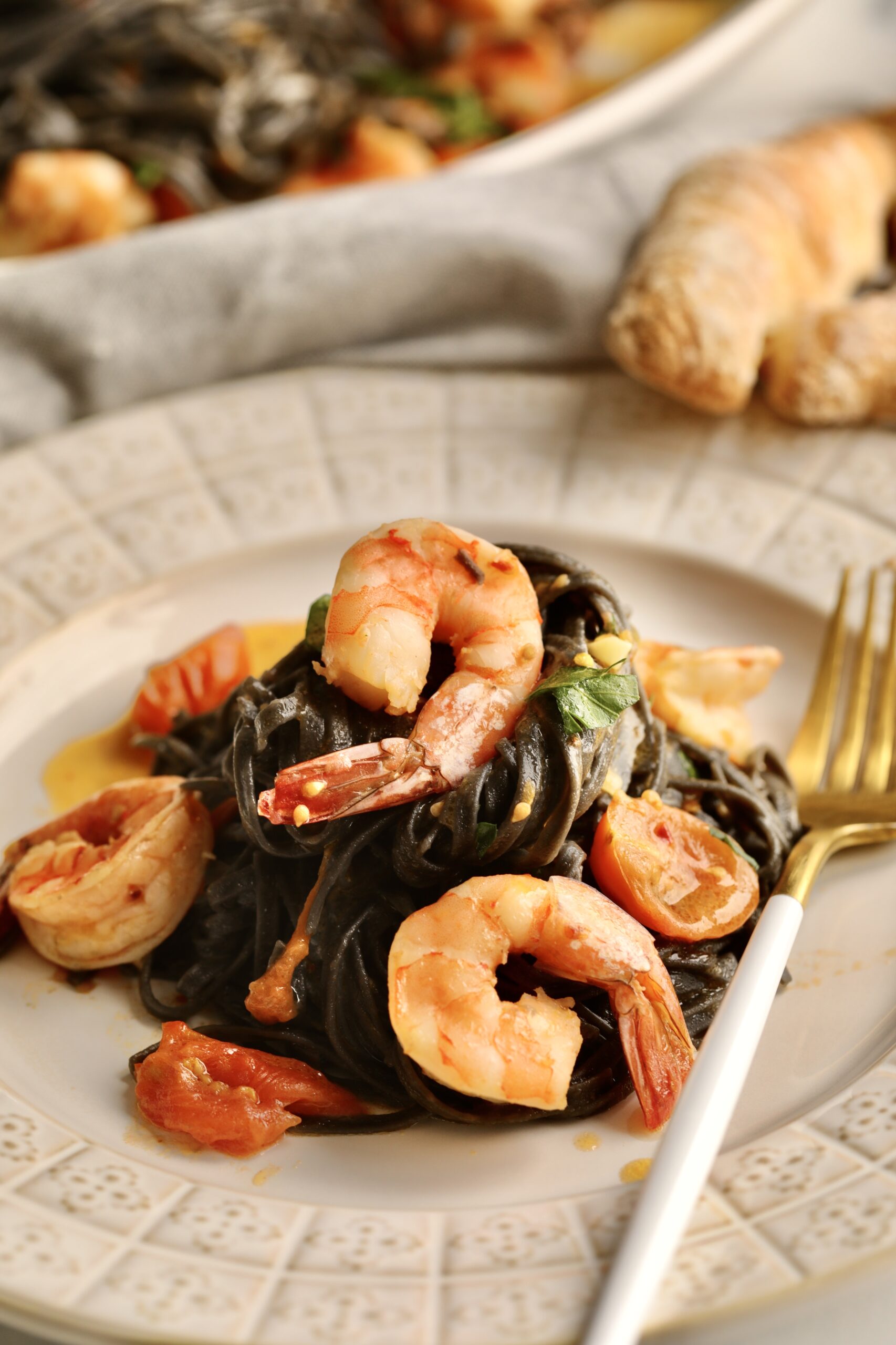 close up of squid ink pasta with shrimp on a plate ready to eat. 