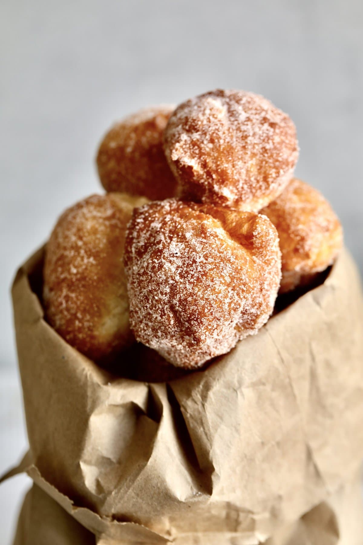 Zeppole Recipe (Easy Italian Donuts)zeppole coming out of brown paper bag.