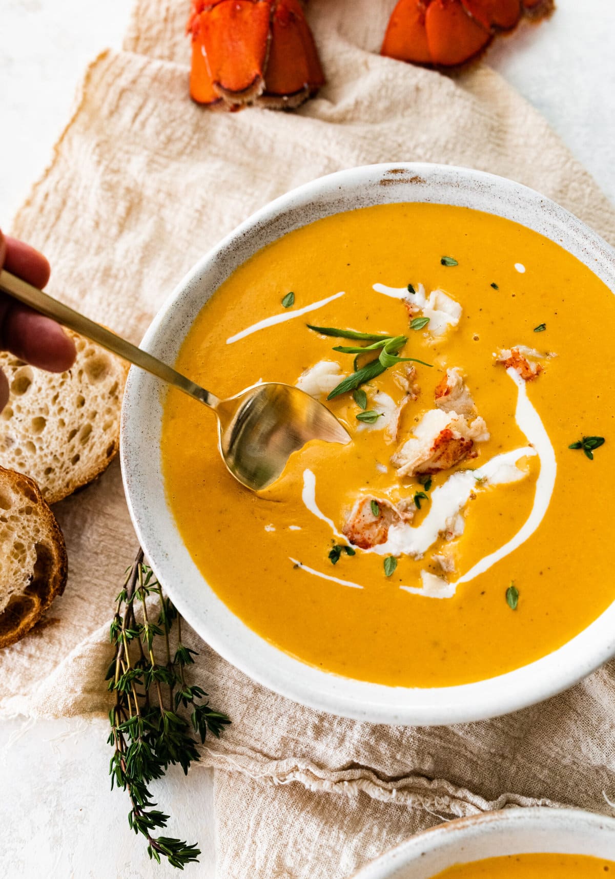 Classic lobster bisque in a bowl with spoon