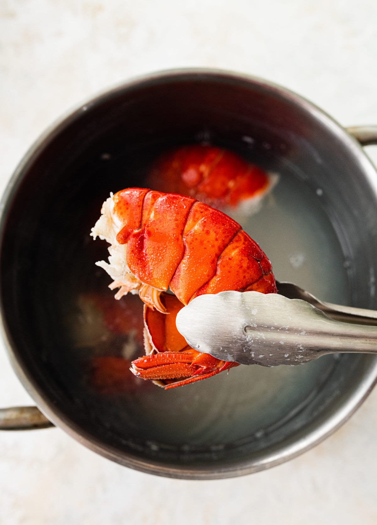 process of making classic lobster bisque: boiling lobster tails.