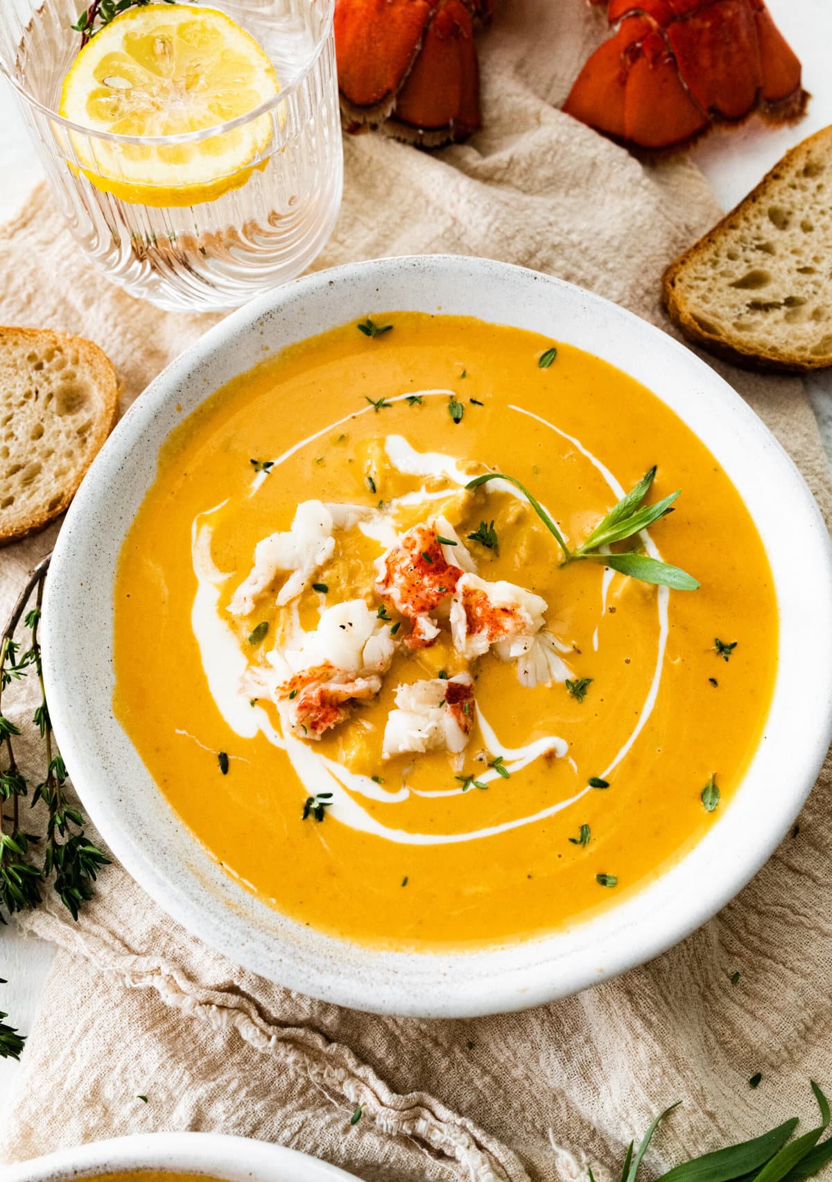 Classic lobster bisque in a bowl with extra lobster on top.