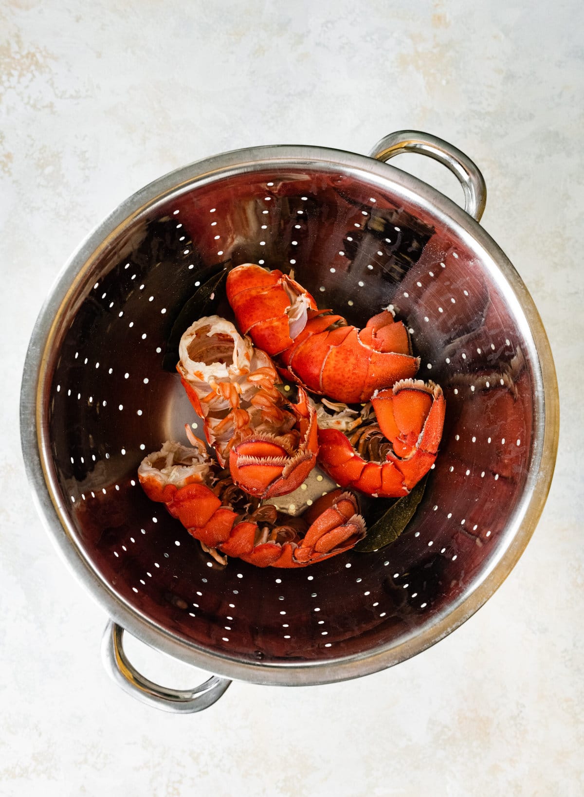 process of making classic lobster bisque: saving lobster tails for broth.