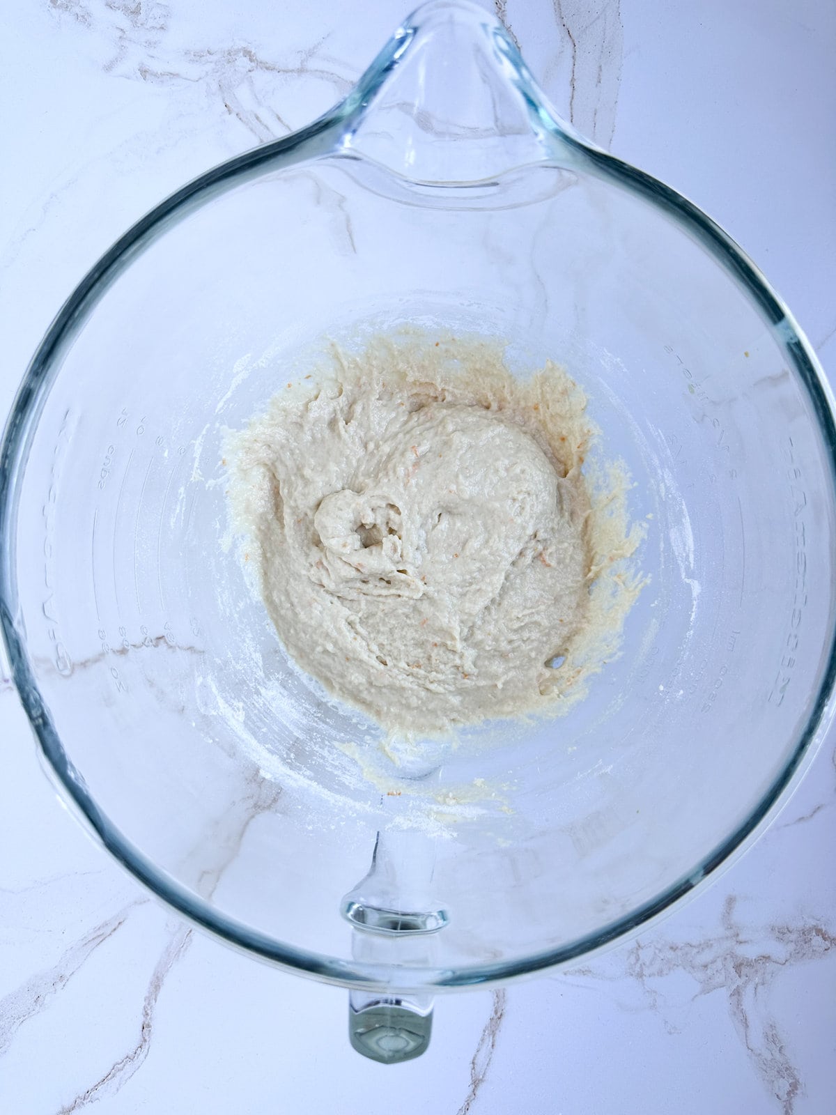 making zeppole dough- mixing the wet and dry ingredients in a mixing bowl.