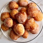 Zeppole donuts piled on a plate.