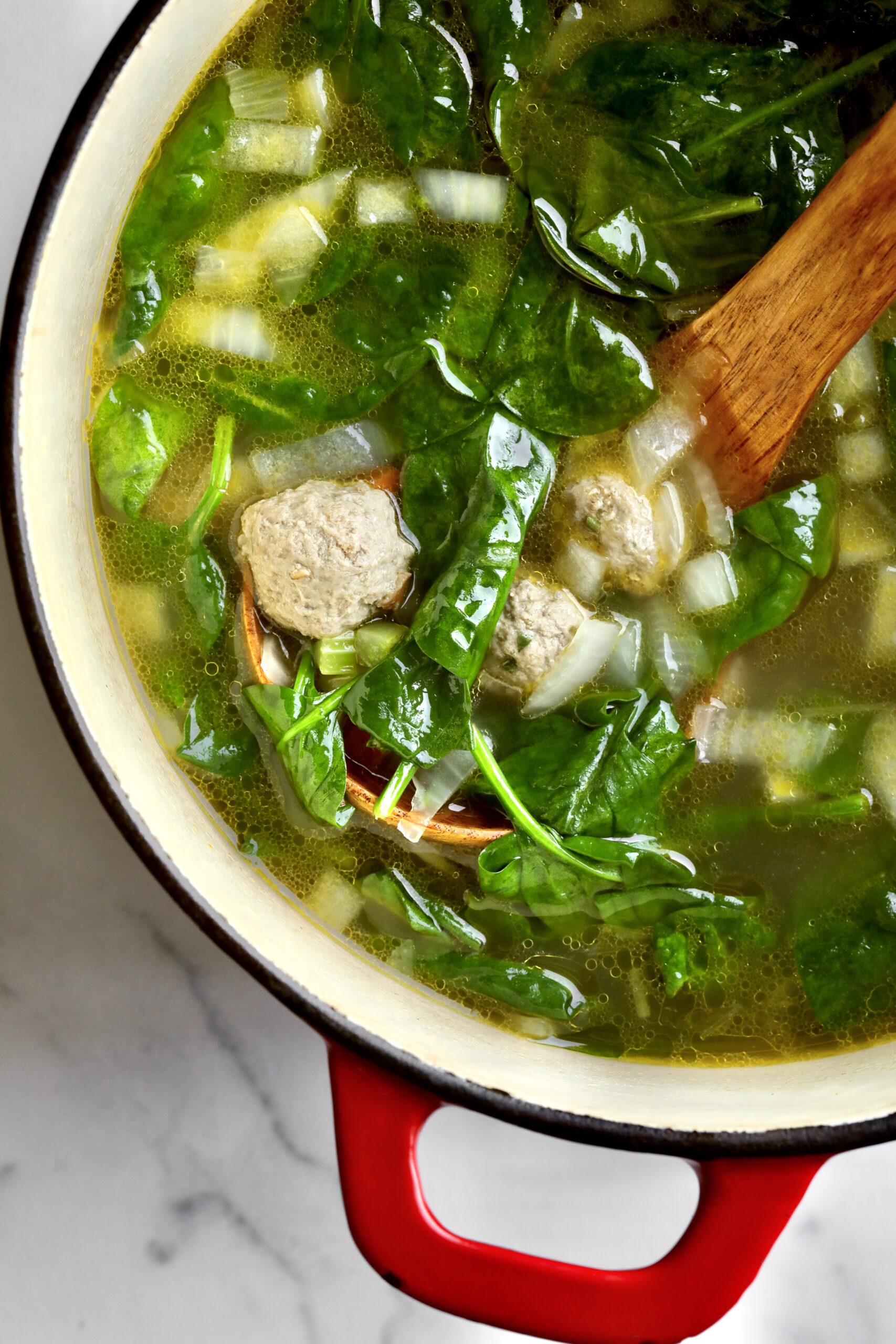 How to make Classic Italian wedding soup recipe process- cooking the spinach in the broth.