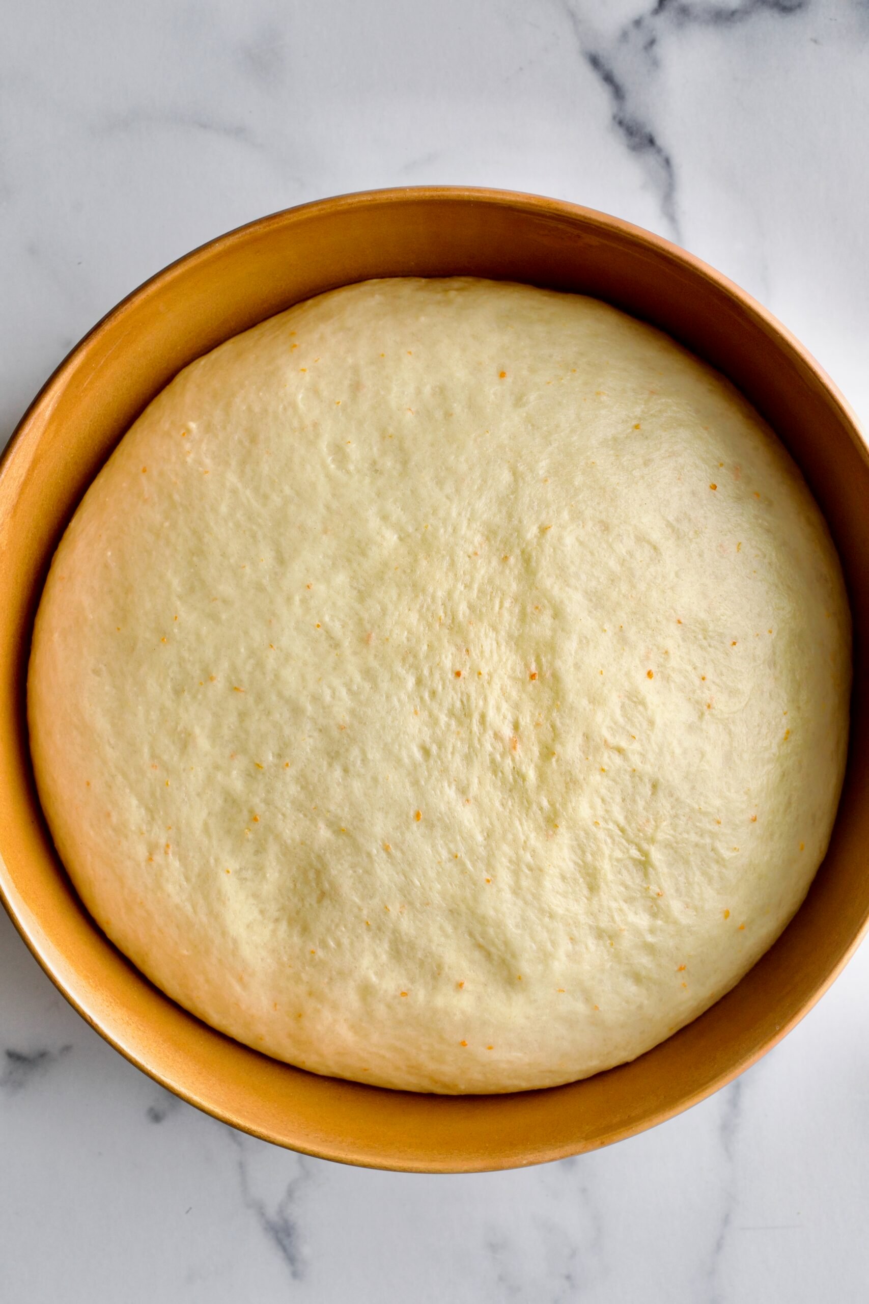 Process of making Bomboloni (how to make bomboloni recipe)- proofed dough after first rise. Triple in size.