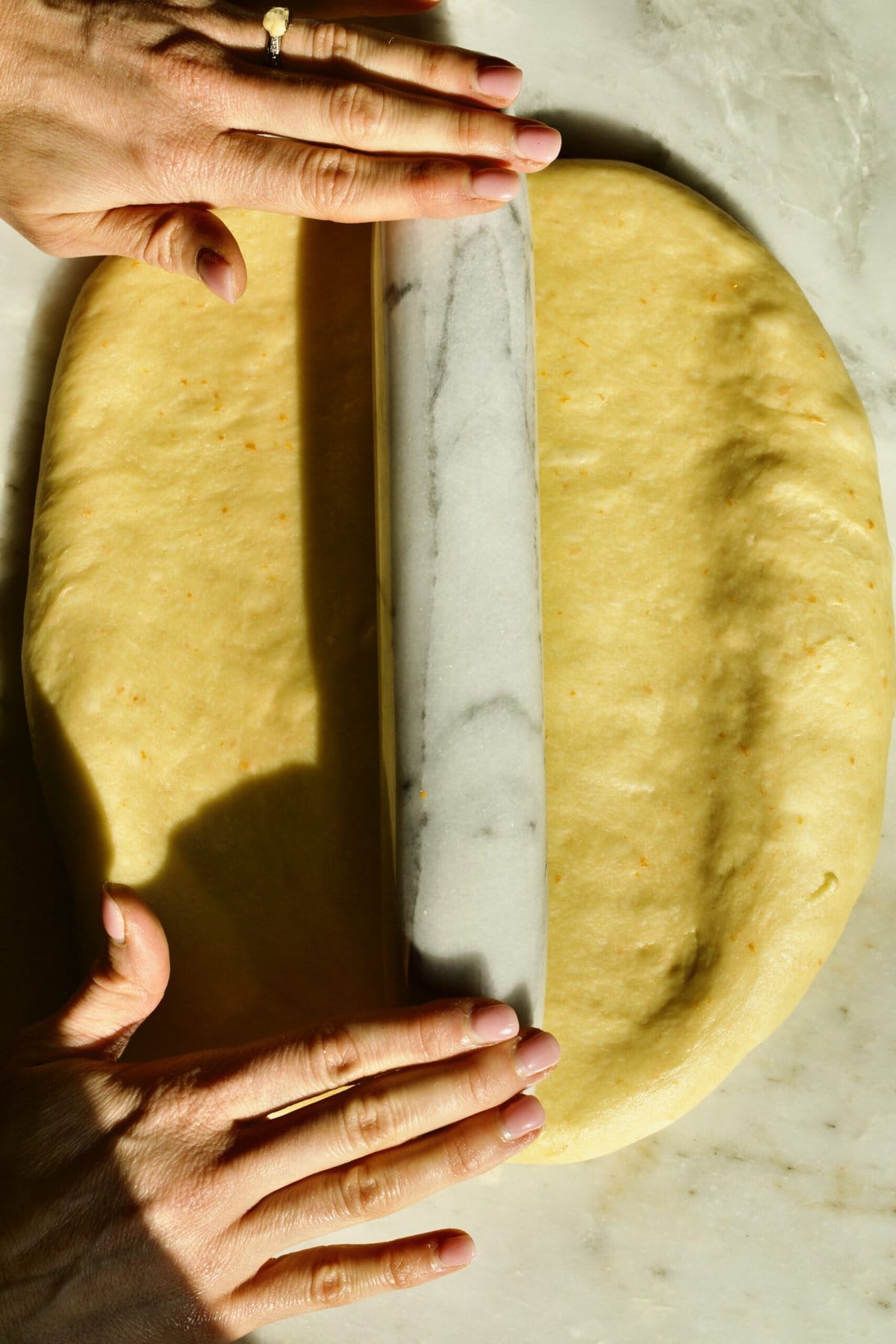 Process of making Bomboloni (how to make bomboloni recipe)- rolling out the dough.