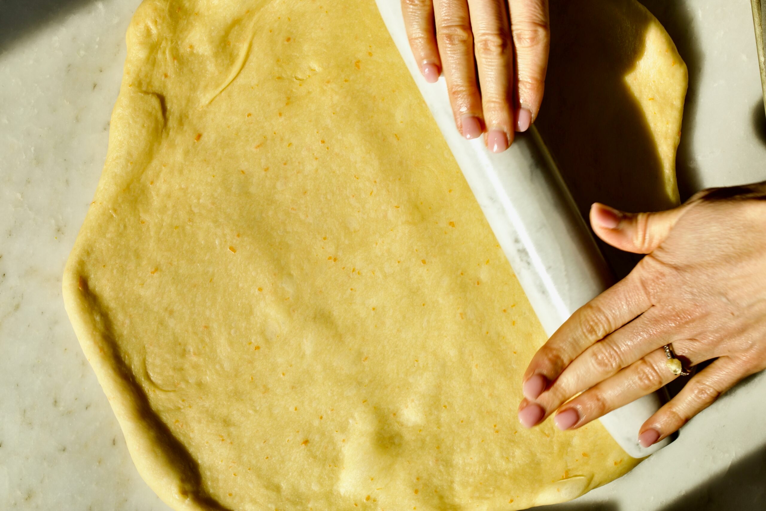 Process of making Bomboloni (how to make bomboloni recipe)- rolling out the dough.