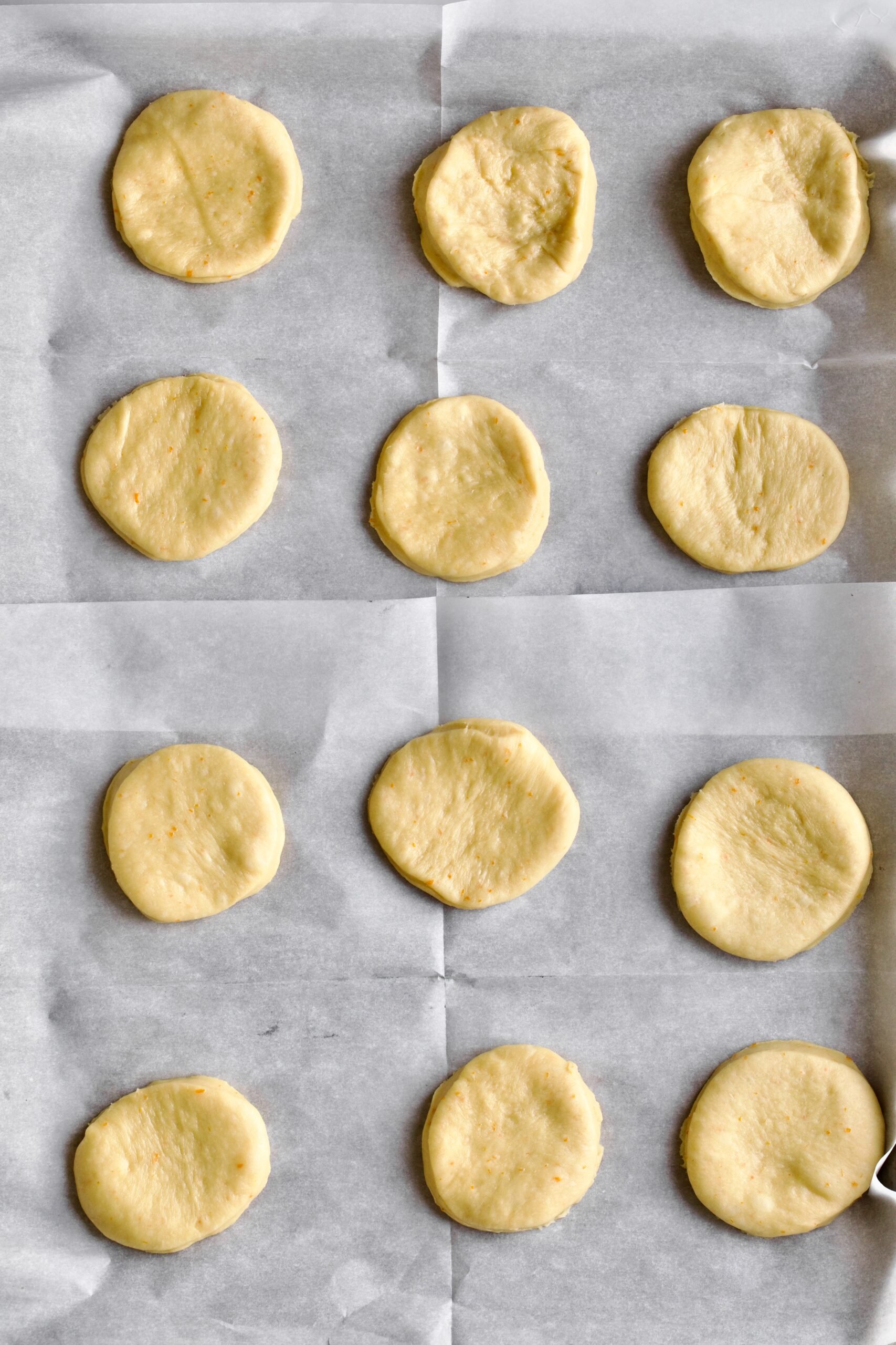 Process of making Bomboloni (how to make bomboloni recipe)- cut out round dough ready for second rise.