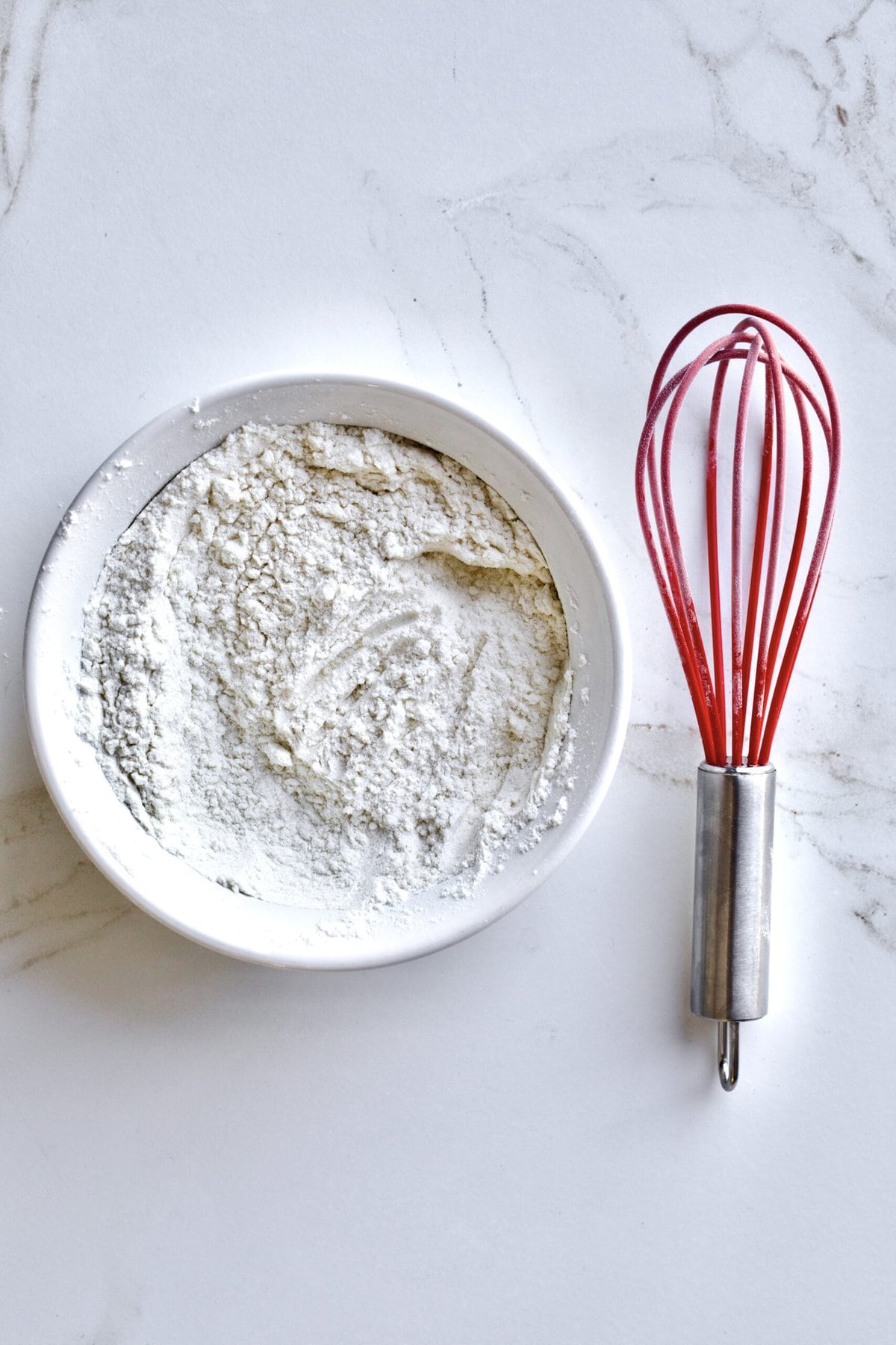 Process of making Baked Zeppole Di San Giuseppe Recipe (Italian)- whisking dry ingredients.