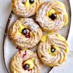 Zeppole di San Giuseppe on an oblong plate.