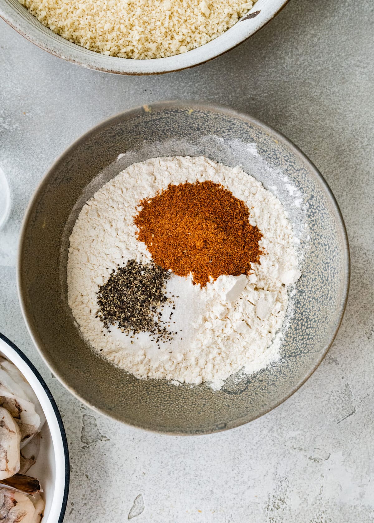 process for how to make Fried Butterfly Shrimp Recipe (Easy and Crunchy)- mixing the flour and herbs in a small bowl