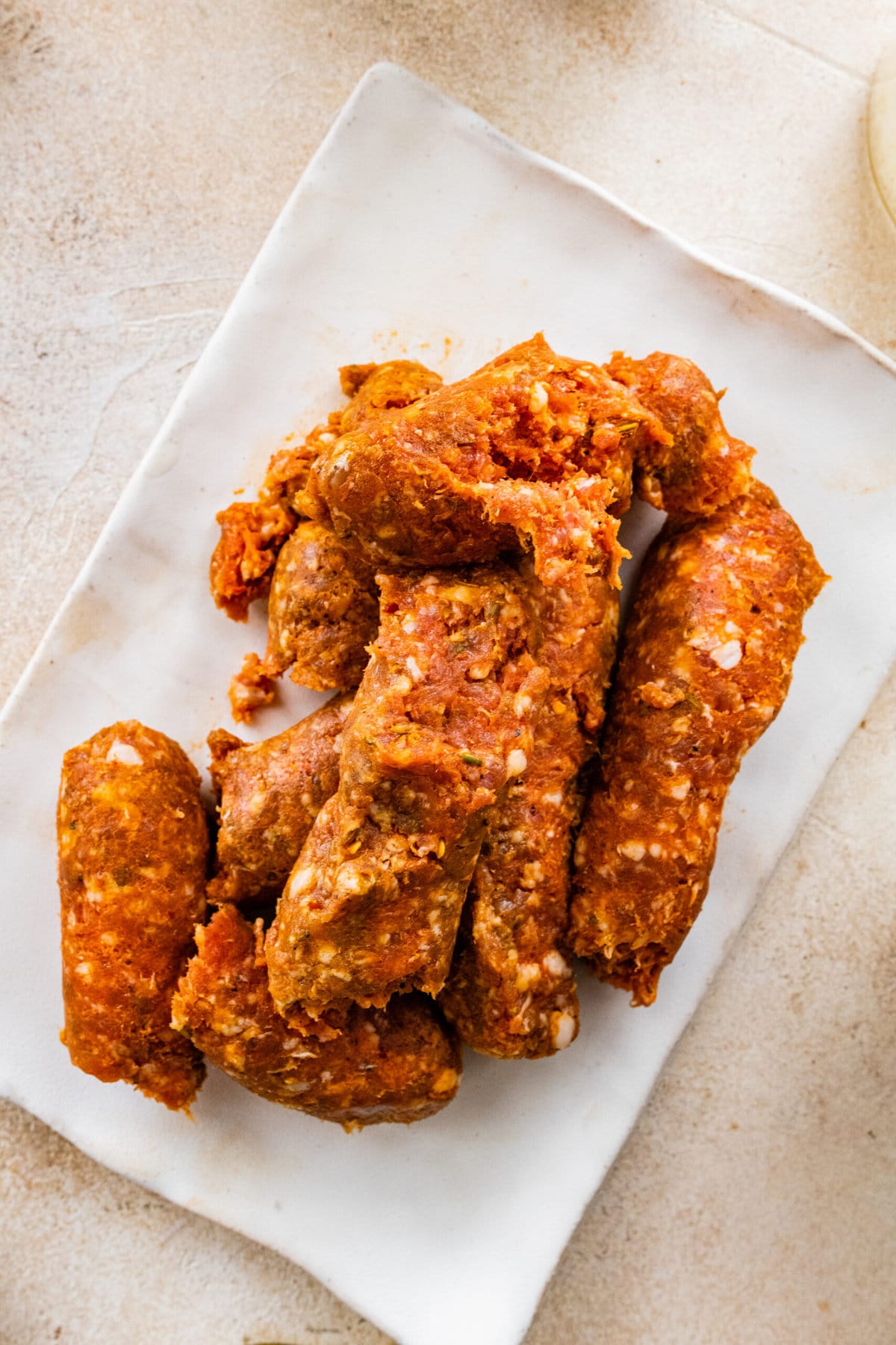 Process for making Italian Sausage Meatballs Recipe (In Sauce)- taking sausage out of casing.