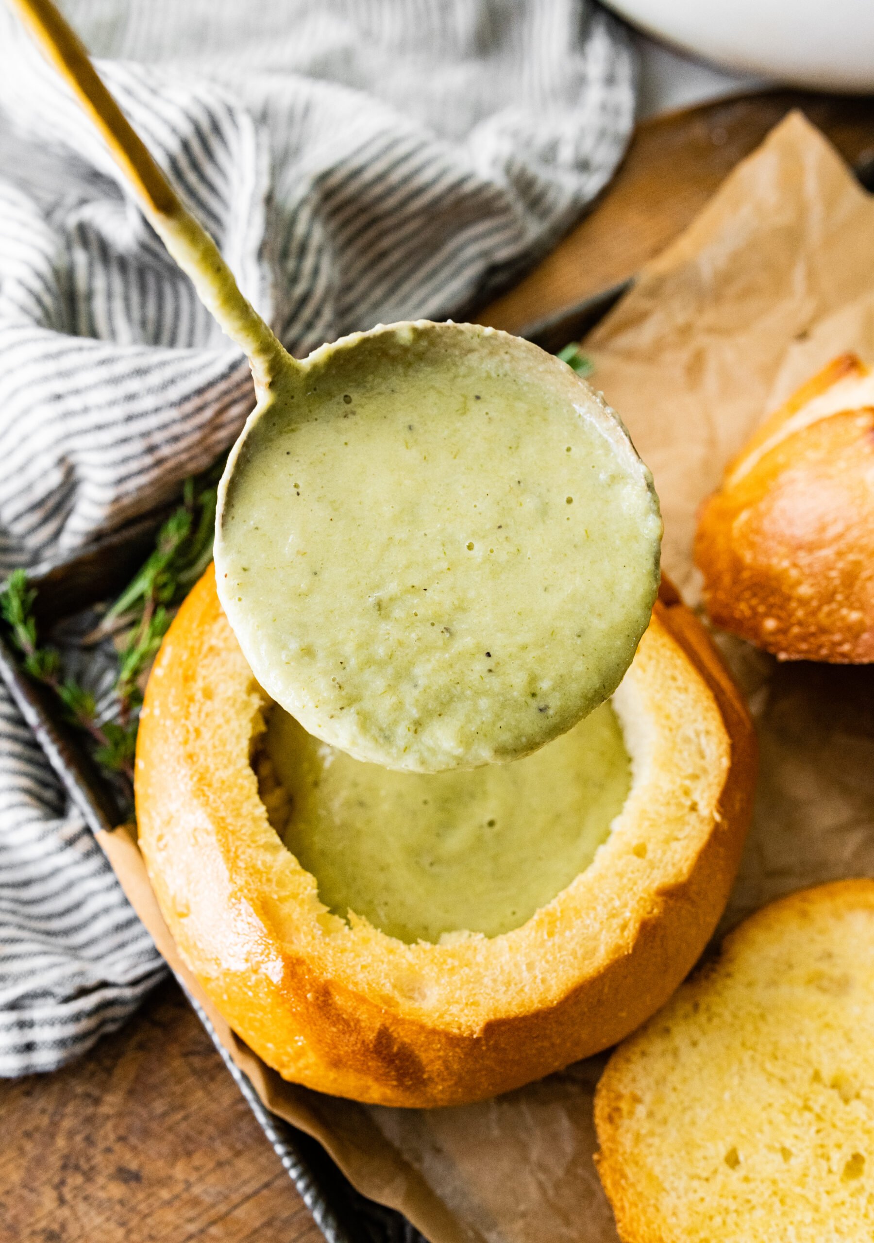 process of making No Potato Leek Soup Recipe- ladling the soup into the soup bowls.