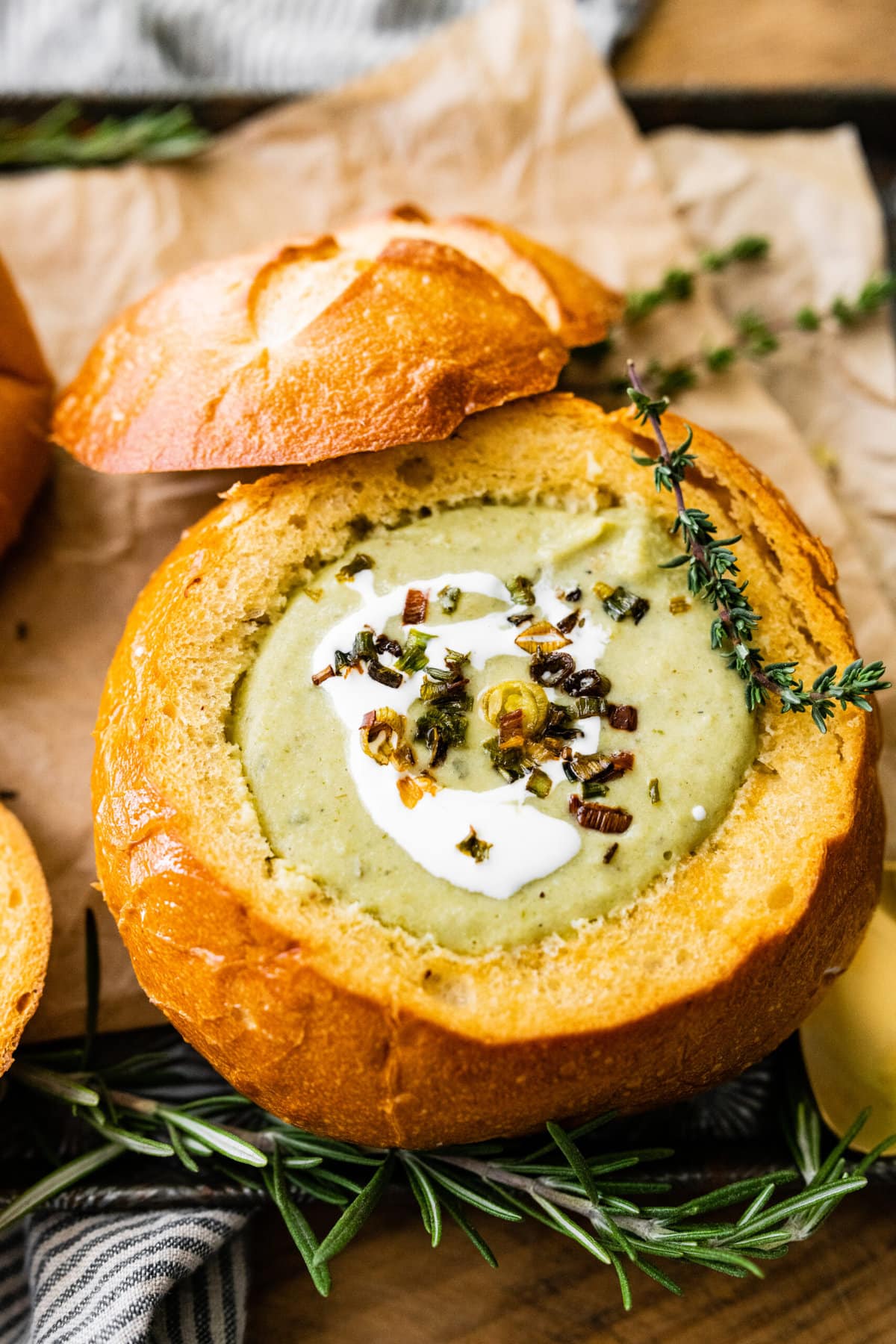 close up of no potato leek soup recipe with cream fraiche and crispy green onions on the top.