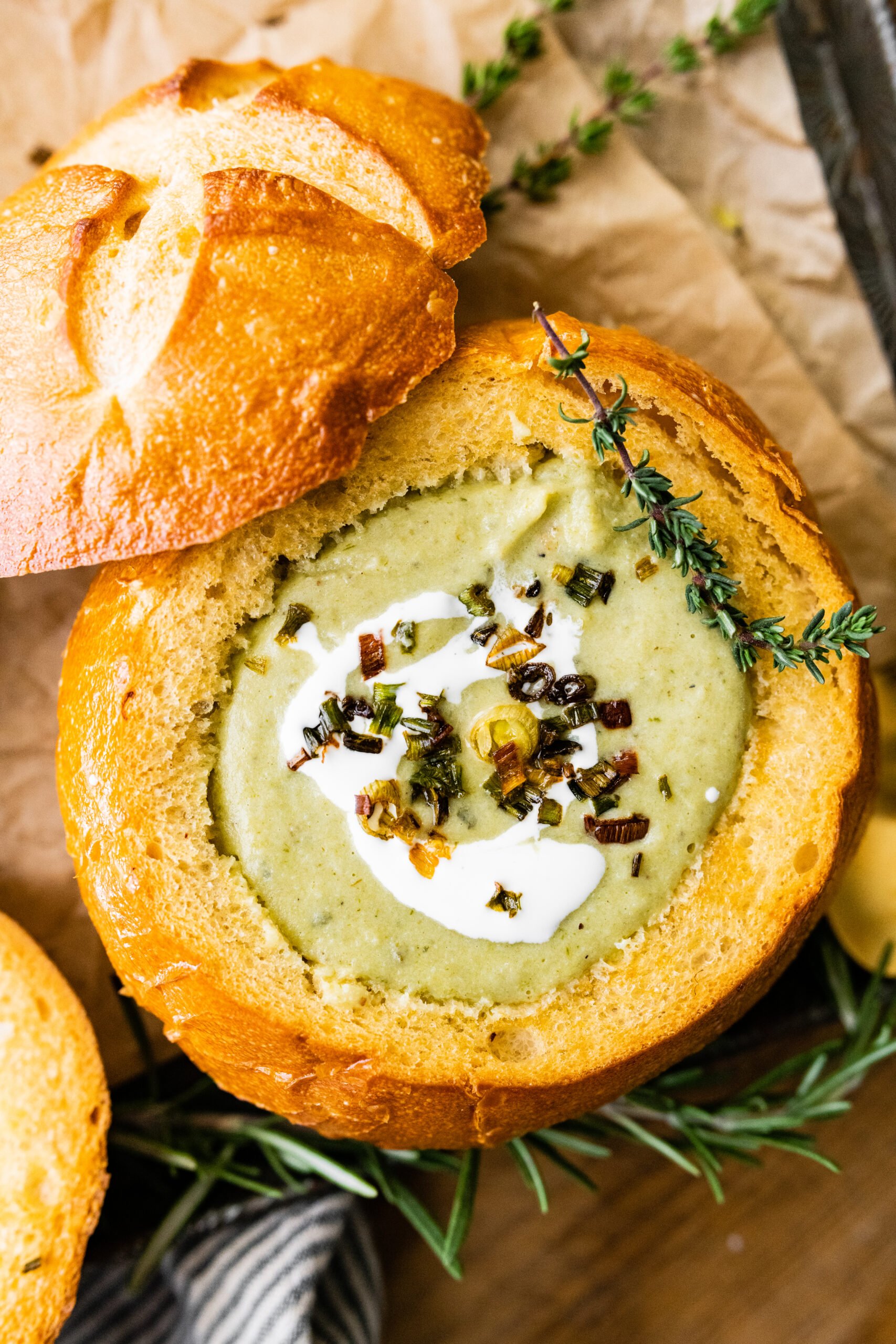 close up of no potato leek soup recipe with cream fraiche and crispy green onions on the top. 