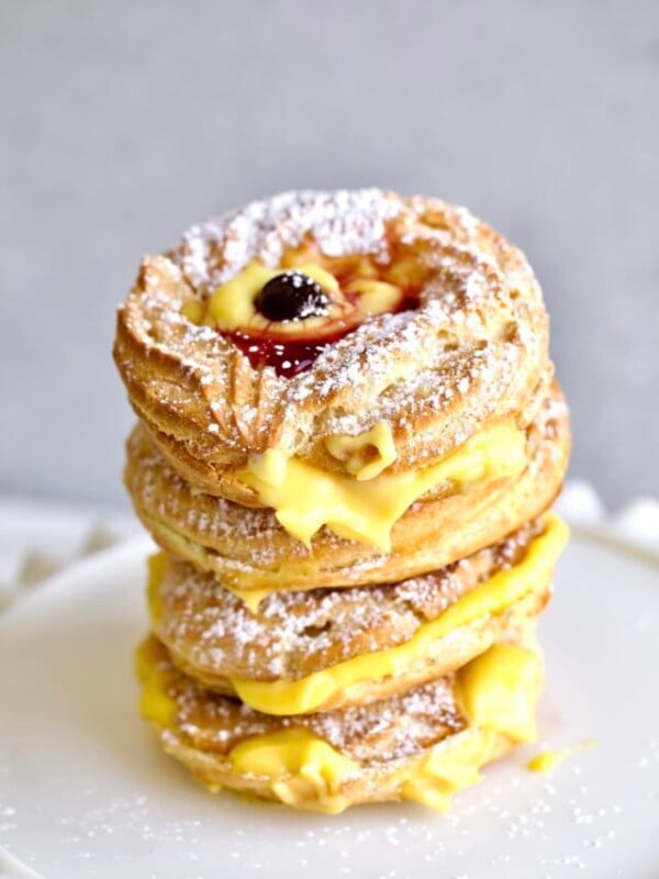 stacked baked zeppole recipe on a ruffled plate serving platter.