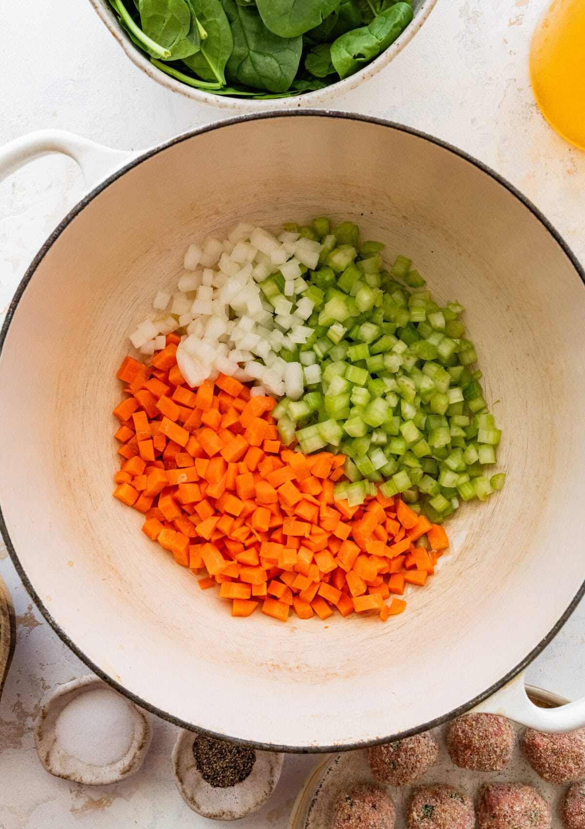 Vegetables added to a Dutch oven to cook.