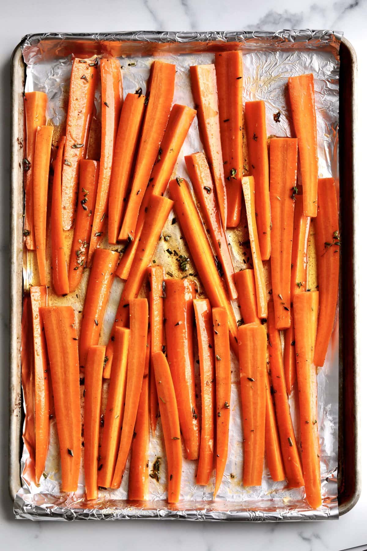 How to makeBest Honey Glazed Carrots Recipe (Oven Roasted)- carrots tossed in glaze and ready to bake.