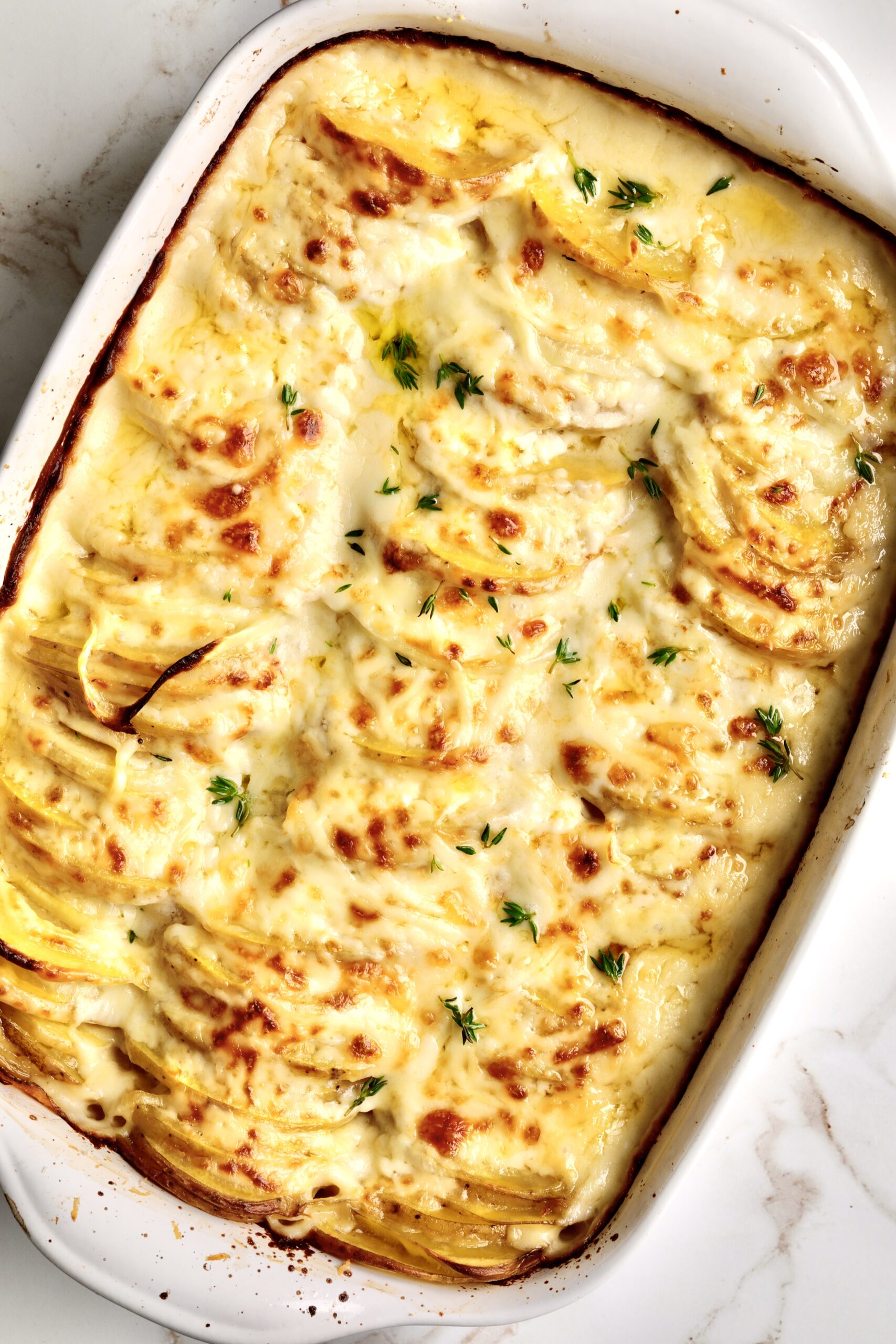 How to make Best Creamy Au Gratin Potatoes Recipe (Dad's Famous)-taking out of the over with golden brown crust.