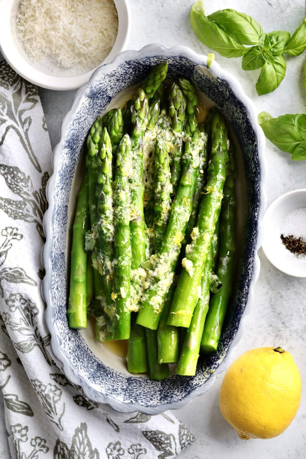 Finished steamed asparagus in a serving dish.