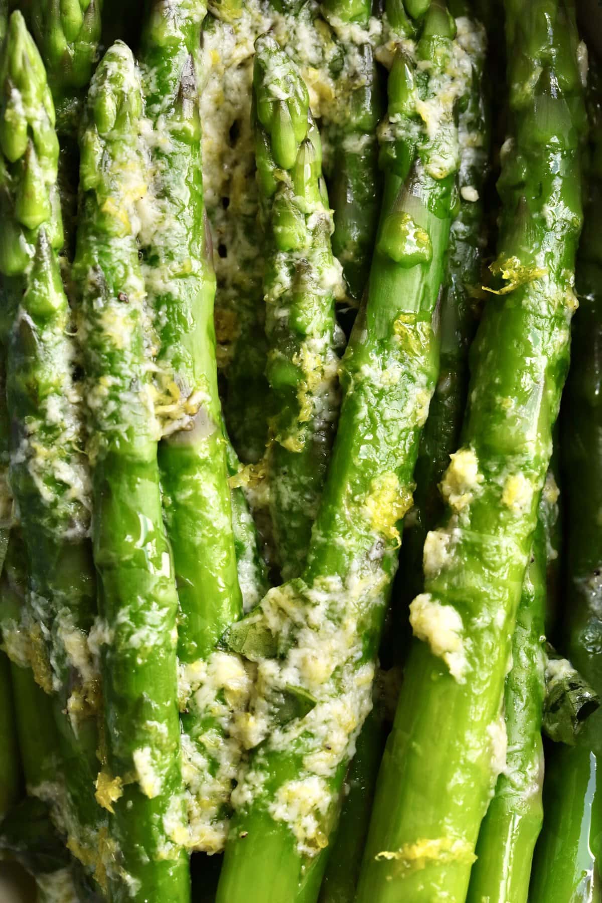 close up of steam asparagus recipe with simple lemon zest sauce.